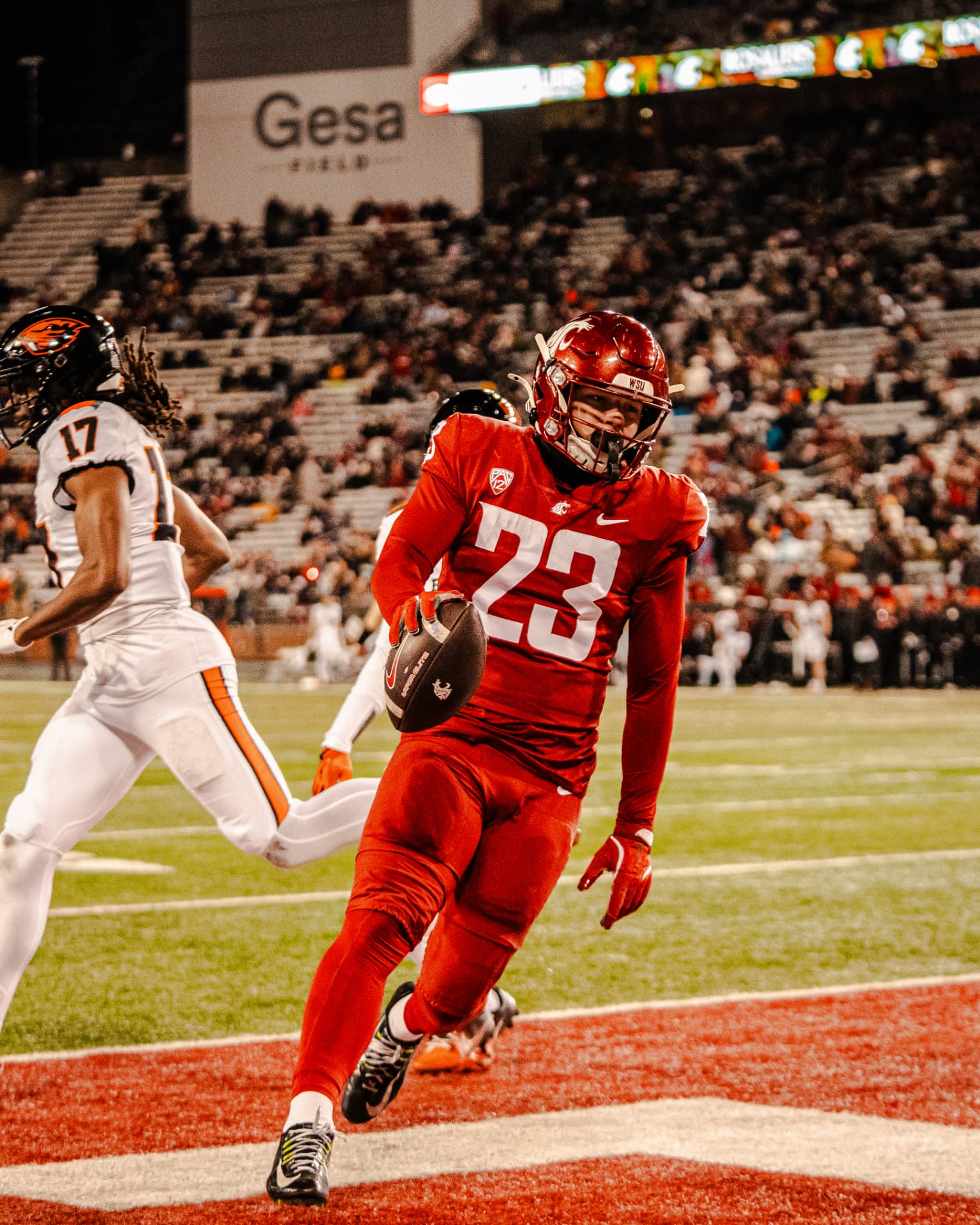 Washington State No. 23 crossing into the end zone under the lights at Gesa Field